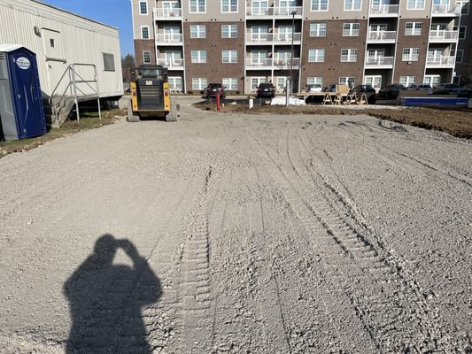 A gravel site pad graded and compacted at a commercial apartment property
